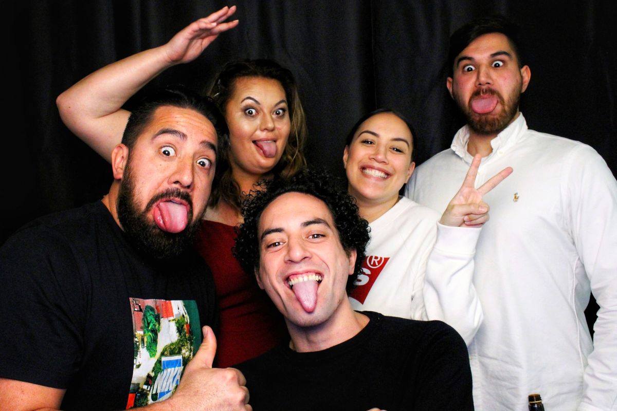 Group posing for photo booth and posing with silly faces